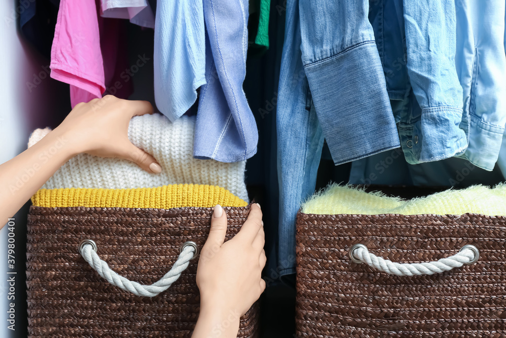 Woman with clean clothes in wardrobe