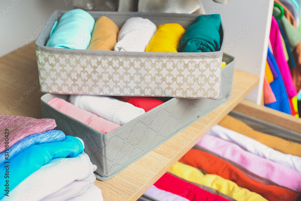 Organizers with clean clothes in closet