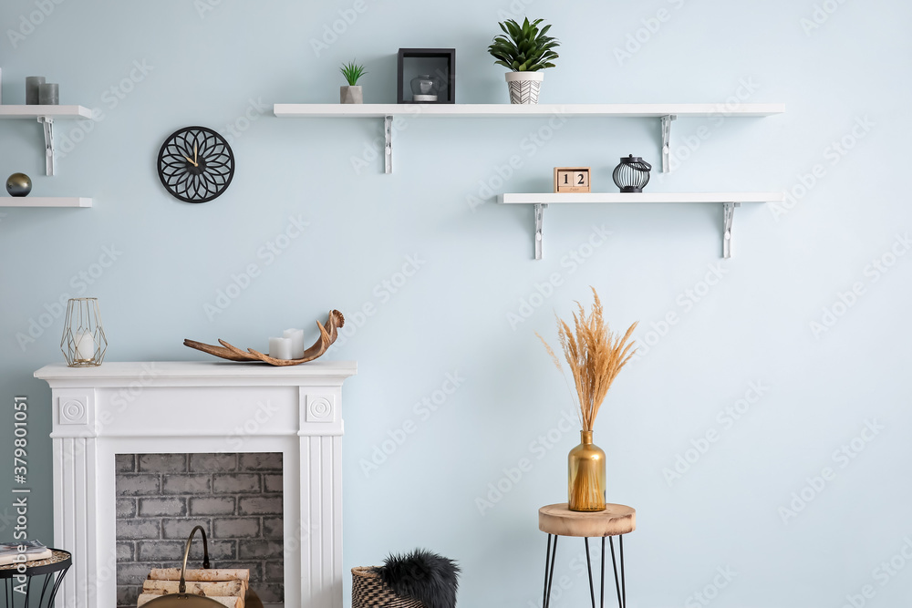 Modern fireplace with shelves in interior of room