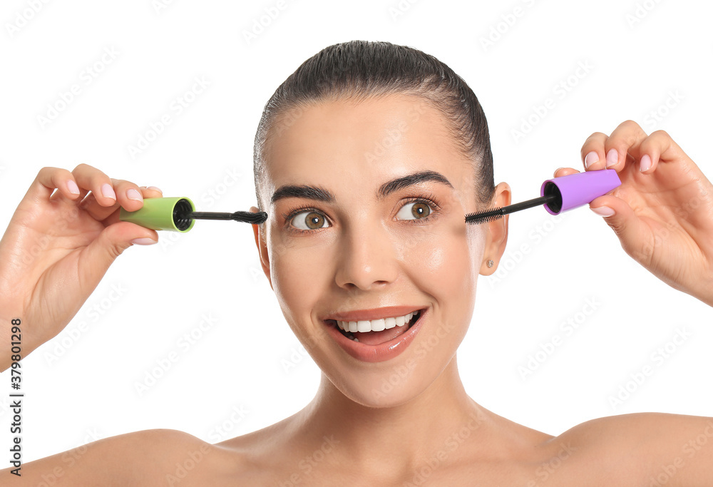 Beautiful young woman with mascara against white background