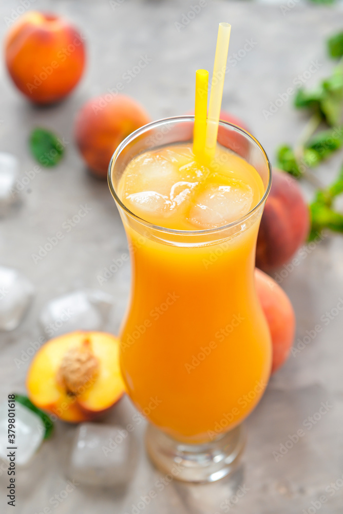 Glass of fresh peach juice on table