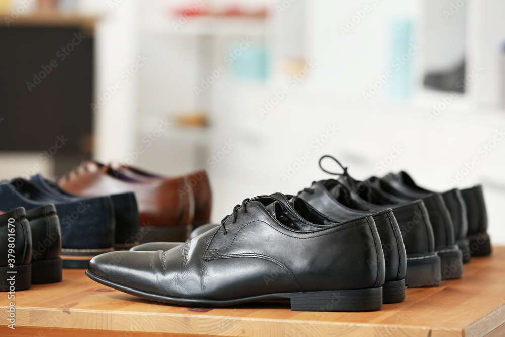 Table with stylish shoes in modern store