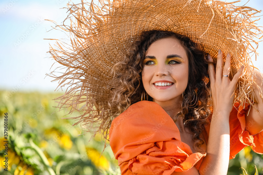 Beautiful young woman in sunflower field