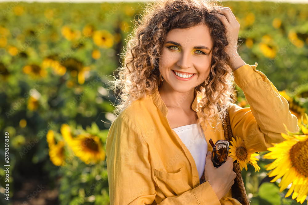 Beautiful young woman in sunflower field