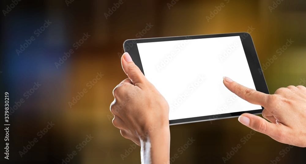 Human hands holding digital tablet with a white blank screen