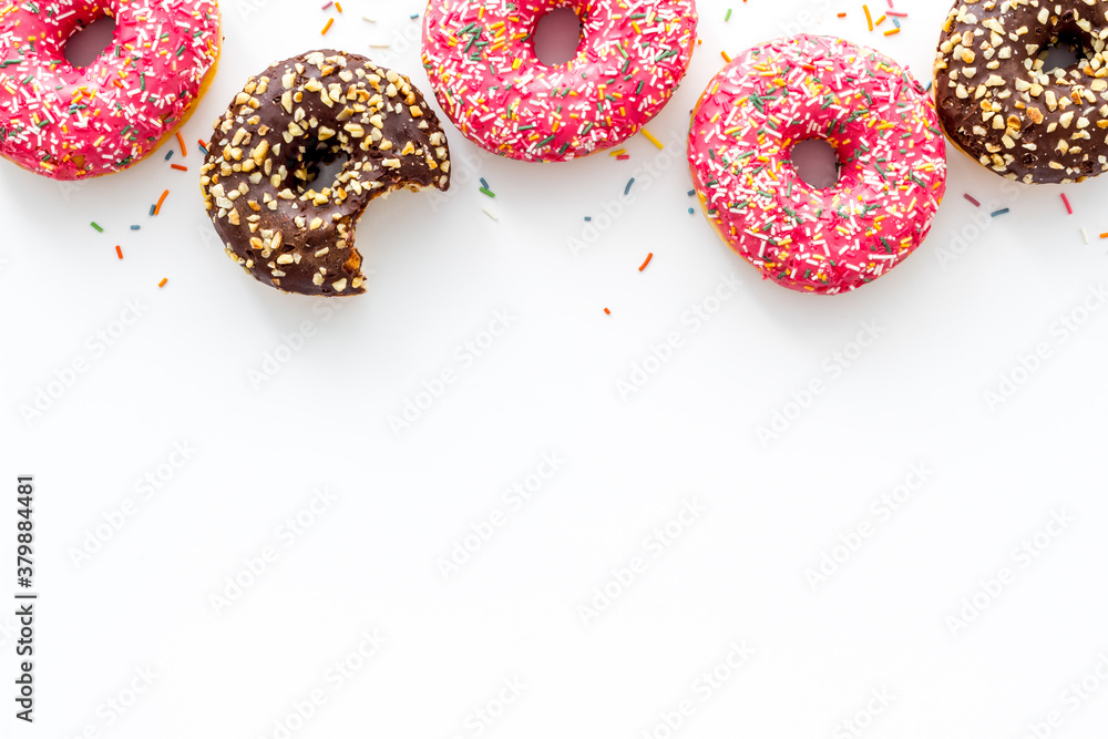 Donuts flat lay pattern on white background, top view