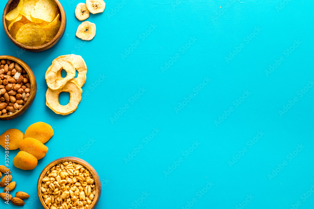 Flat lay of appetizers and snacks overhead. Nuts and dried fruits with crackers