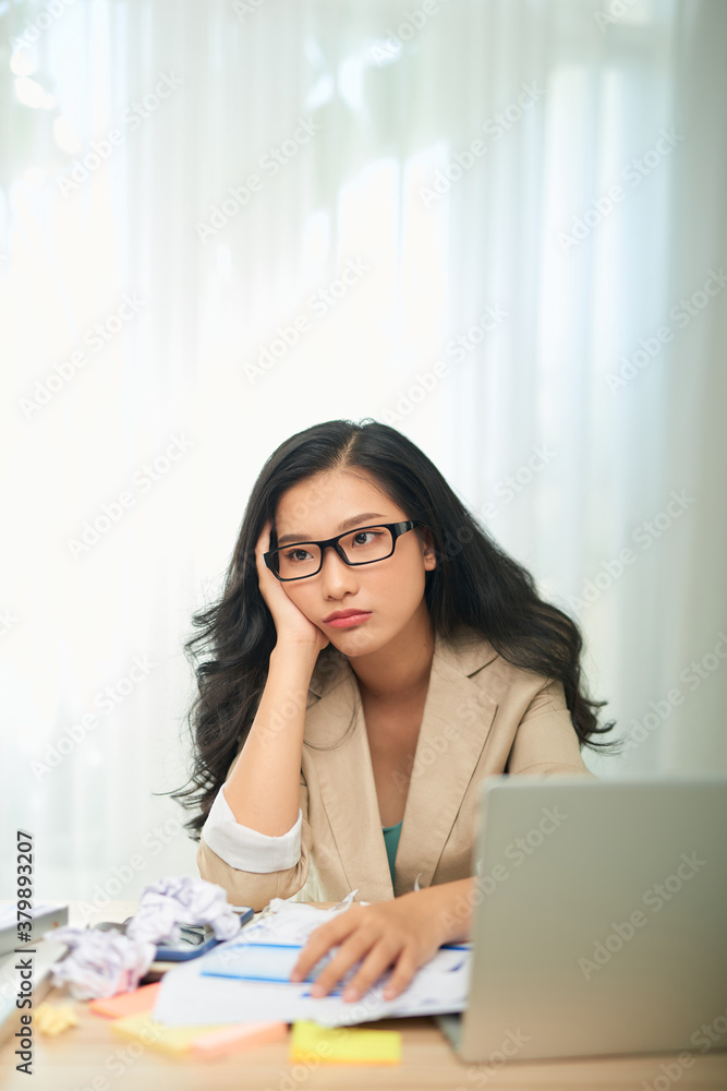 Bored young woman sit at home office table look in distance unable to work at laptop,