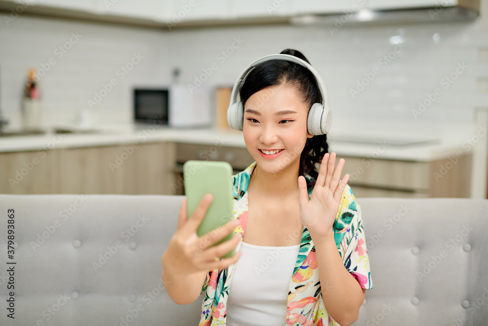 Female housewife talking via messenger app having video chat on mobile phone