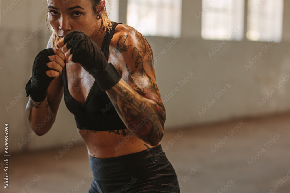 Female doing shadow boxing in training gym