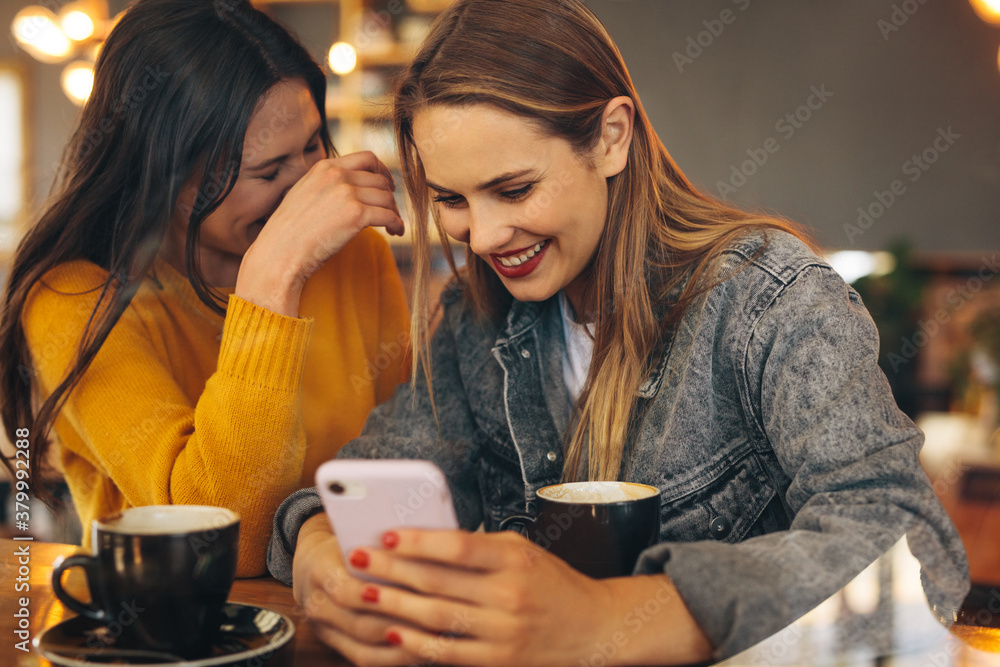 Cheerful friends meeting at a cafe