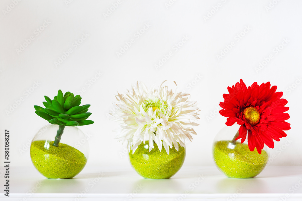 Romantic decoration. flowers in decorated glass jars as a decoration for a table