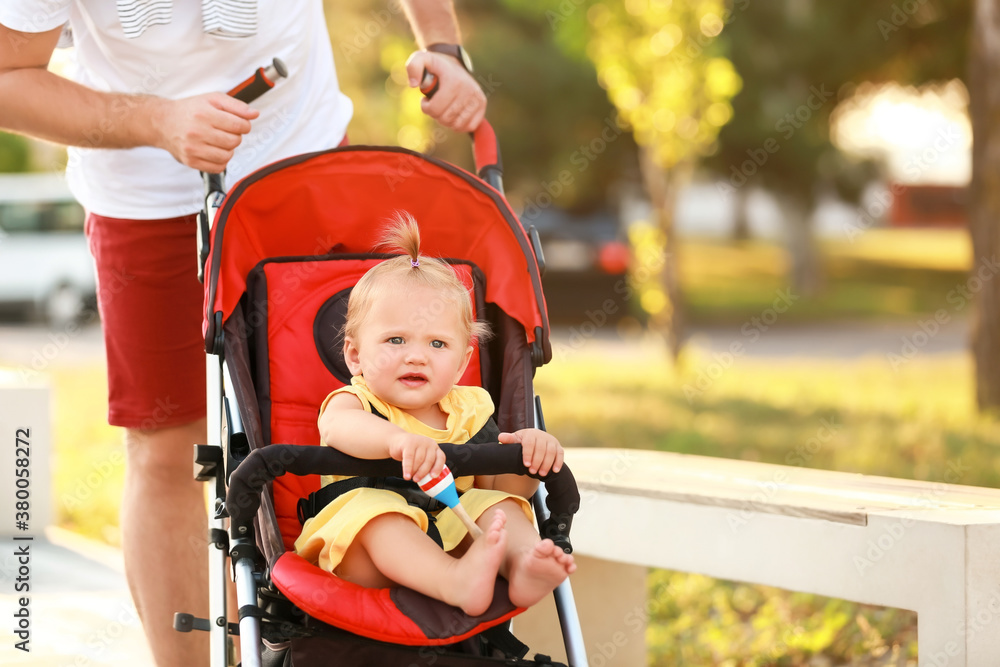 Man and his cute baby in stroller outdoors