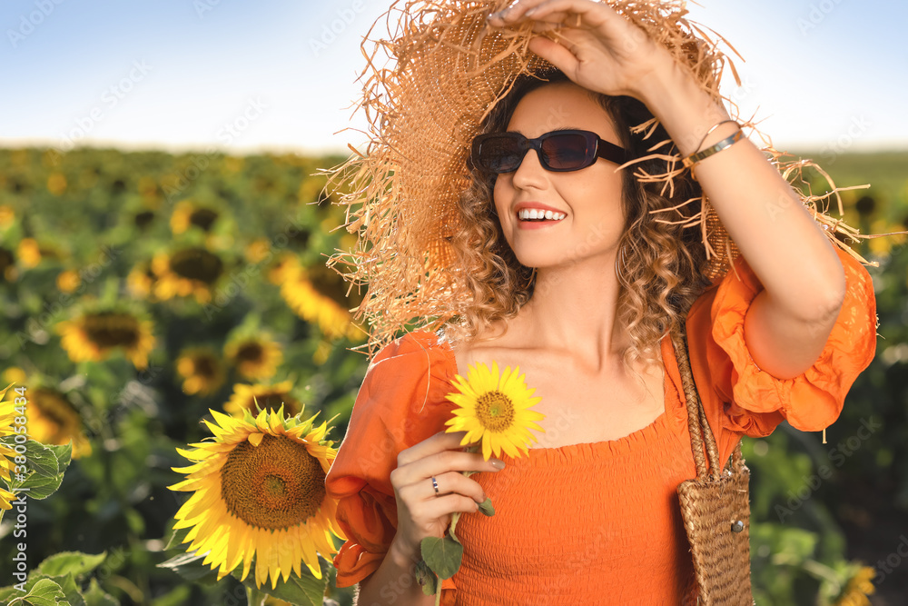 Beautiful young woman in sunflower field