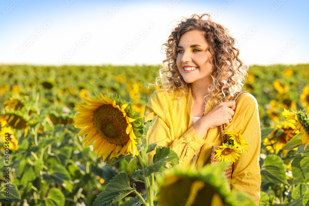 Beautiful young woman in sunflower field