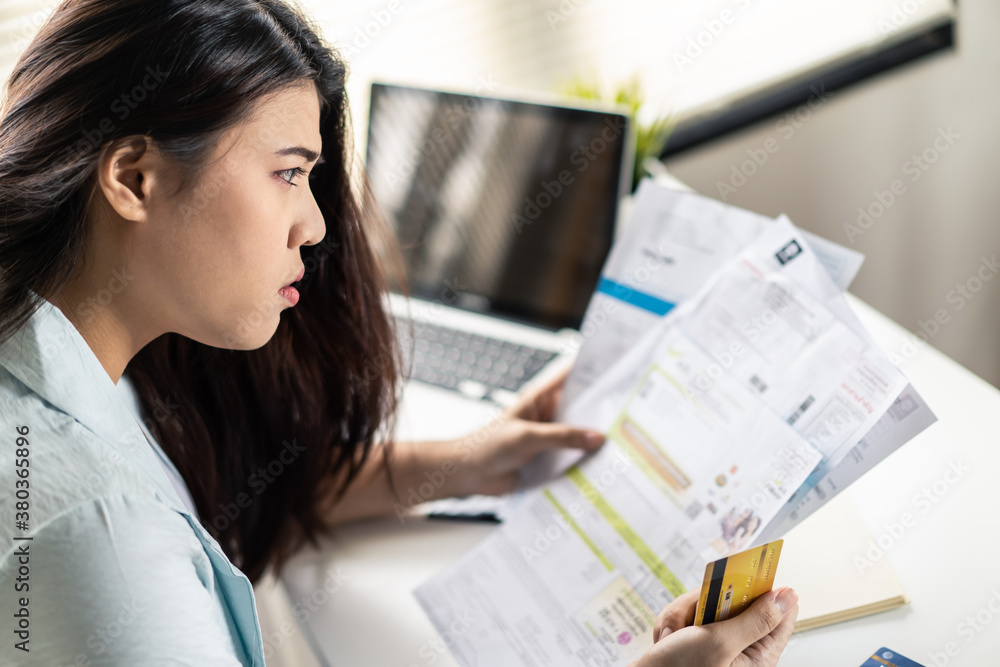 Asian young woman being stressed about her credit card debt problems.