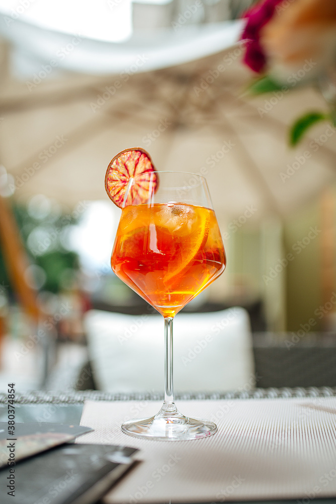 Glass of aperole spritz cocktail with orange slice