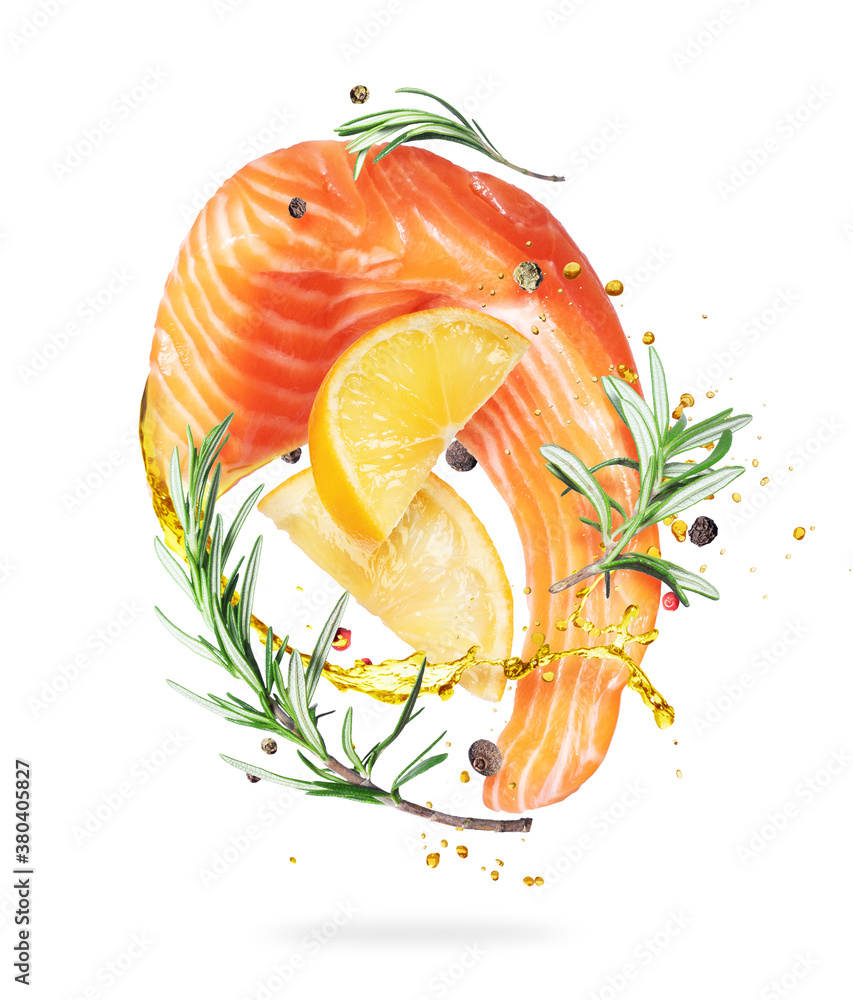 Slice of fresh salmon with flavored spices and lemon in the air