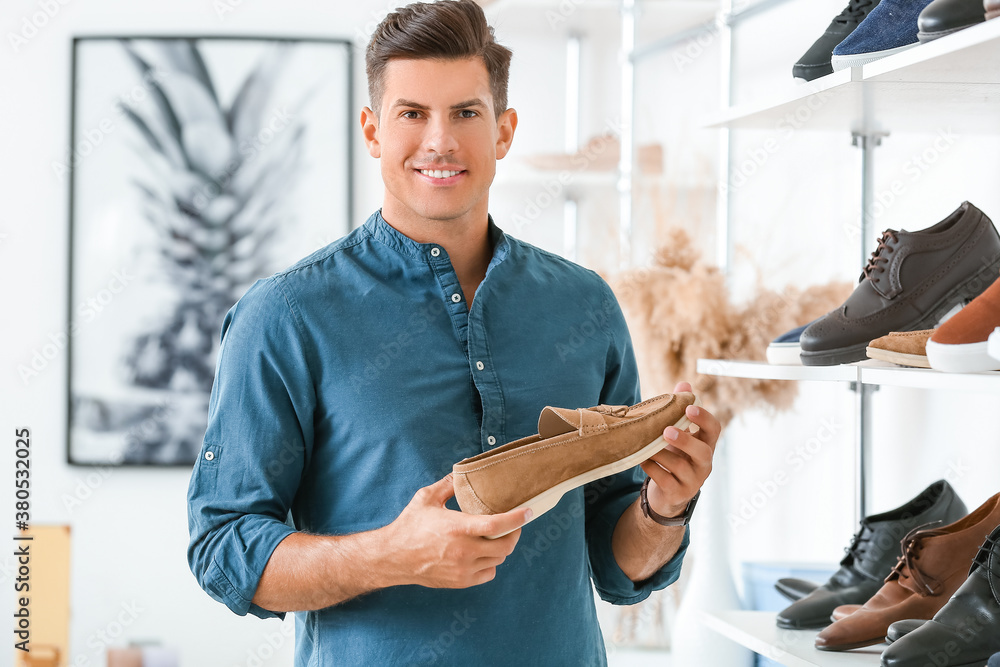 Man choosing new shoes in modern store