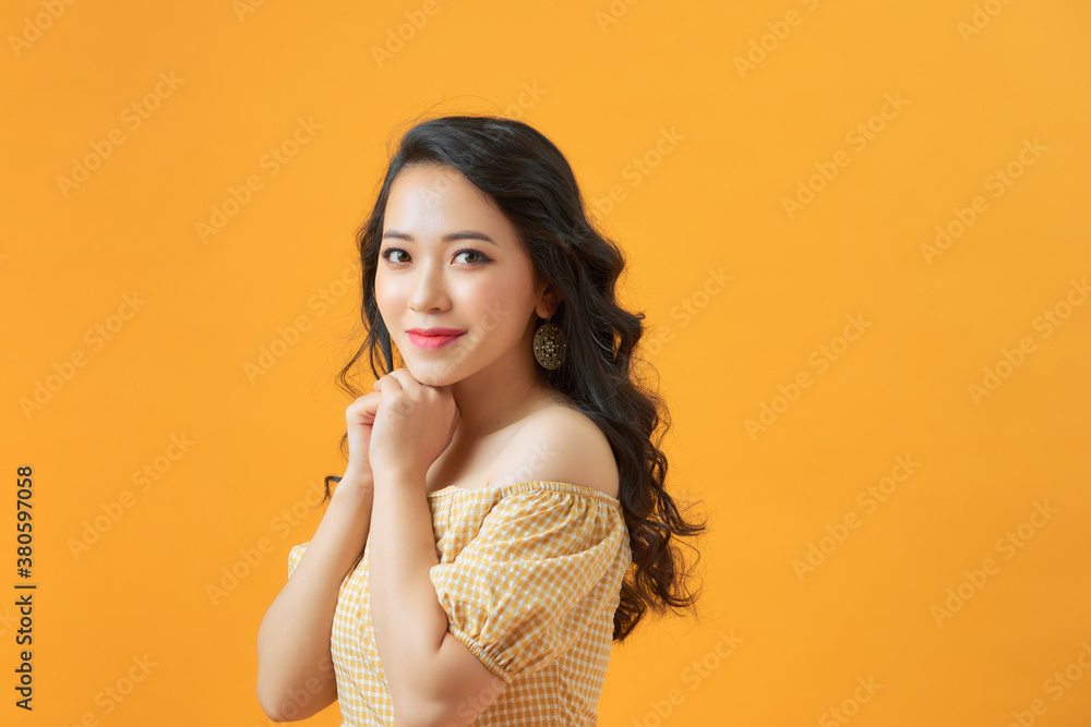 Close up photo of choosing girl making up her mind about something while isolated with yellow backgr