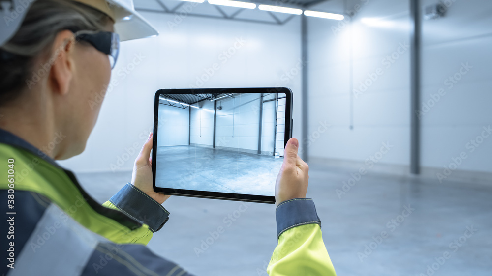 Industry 4.0 Modern Factory: Female Engineer Uses Digital Tablet Computer with Augmented Reality Sof