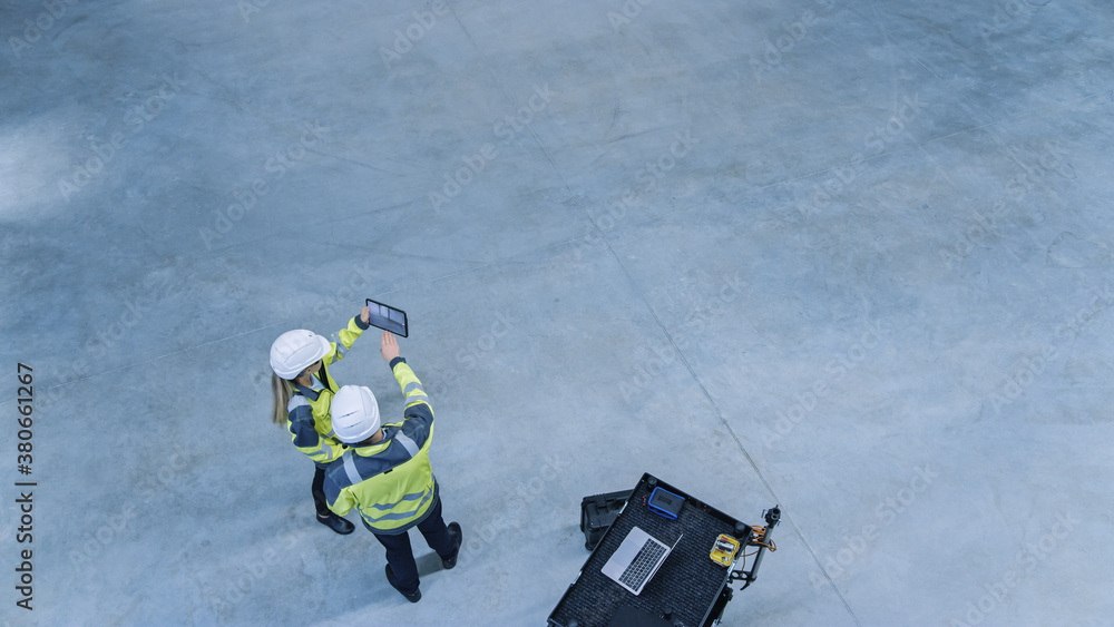 Industry 4.0 Modern Factory: Two Engineers Use Digital Tablet Computer with Augmented Reality Softwa