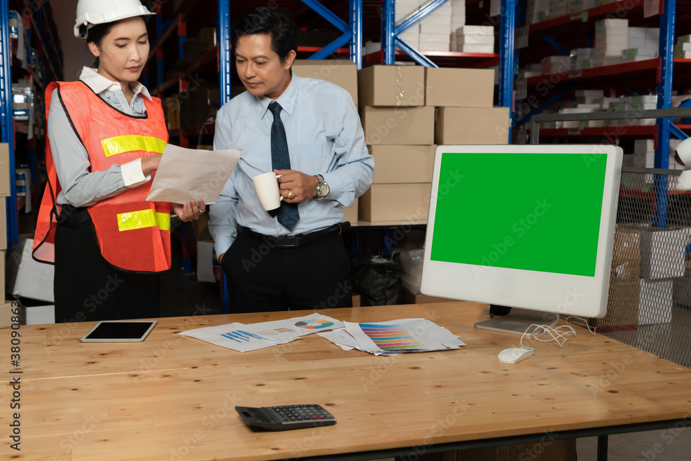 Computer with green screen display in warehouse storage room . Delivery and transportation software 