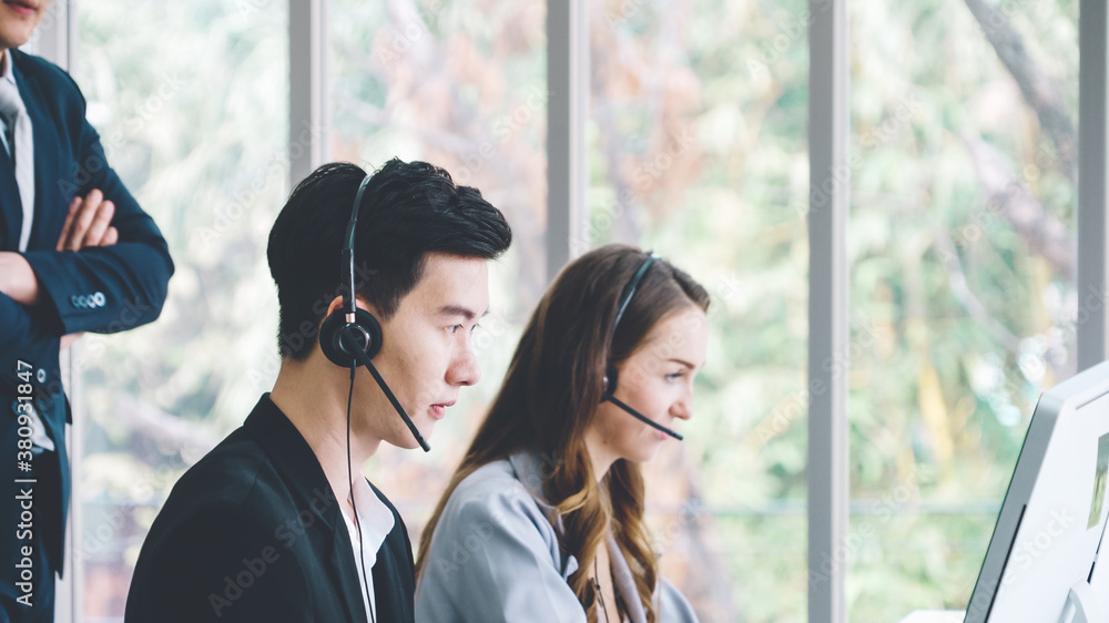 Business people wearing headset working in office to support remote customer or colleague. Call cent