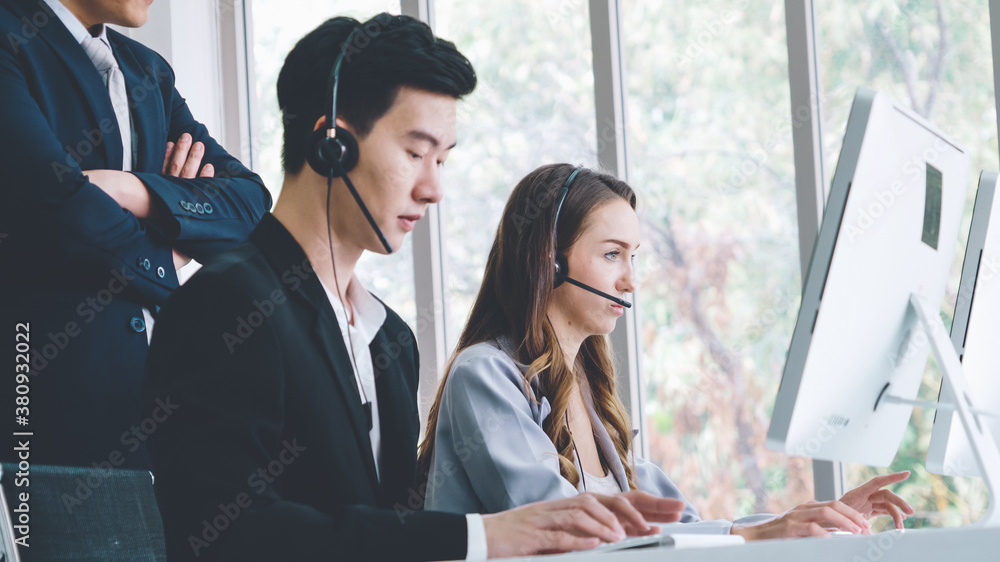 Business people wearing headset working in office to support remote customer or colleague. Call cent