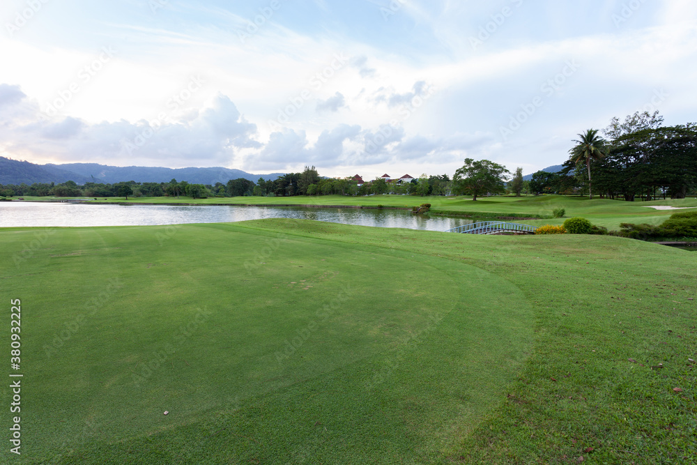 Golf course green grass field and lagoon.