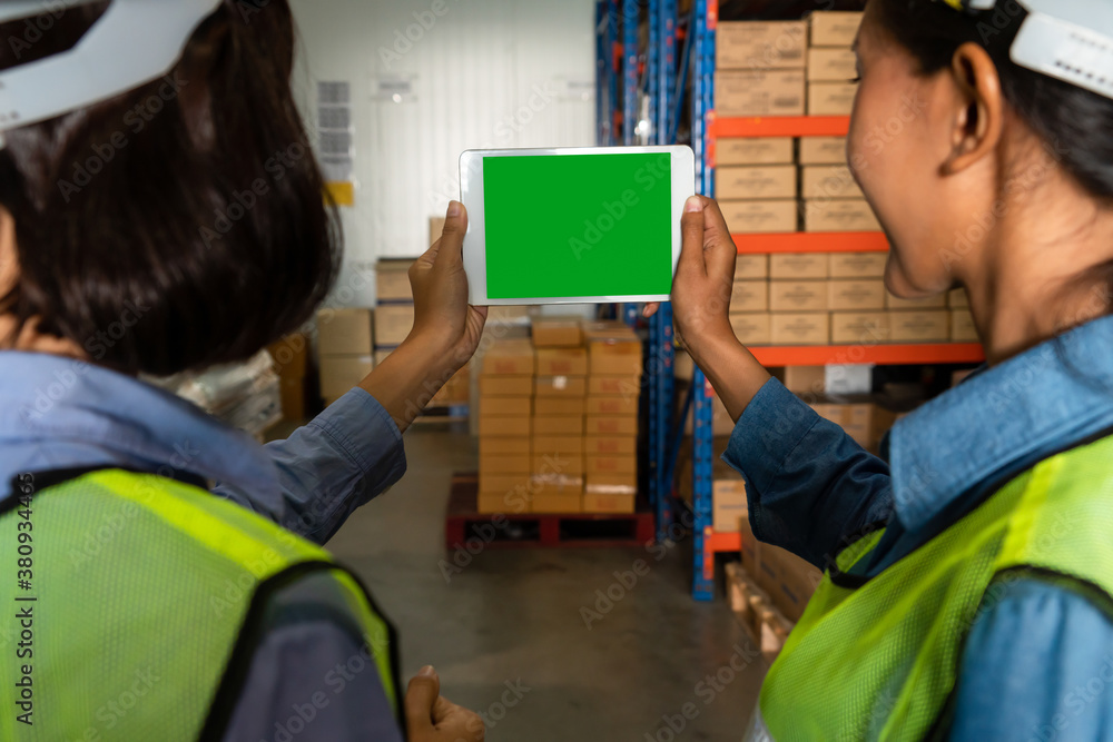 Computer with green screen display in warehouse storage room . Delivery and transportation software 