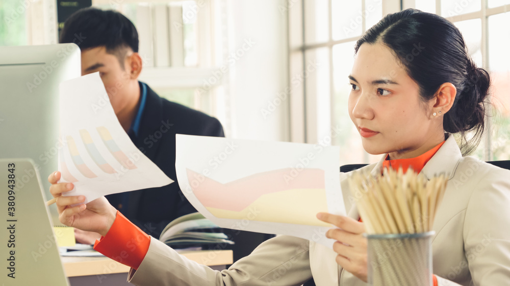 Business people working at table in modern office room while analyzing financial data report .