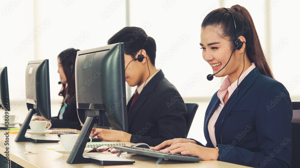 Business people wearing headset working in office to support remote customer or colleague. Call cent