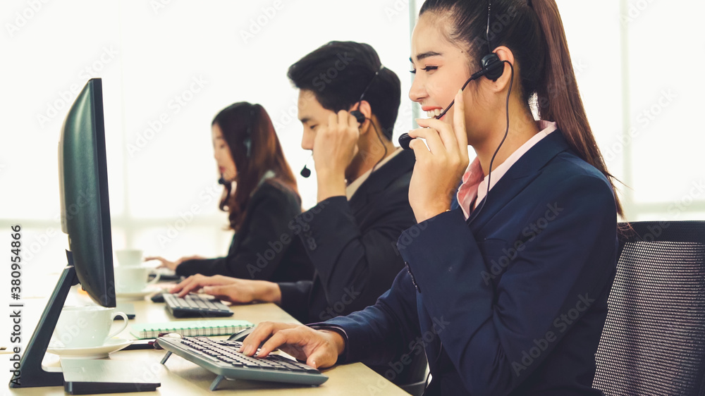 Business people wearing headset working in office to support remote customer or colleague. Call cent