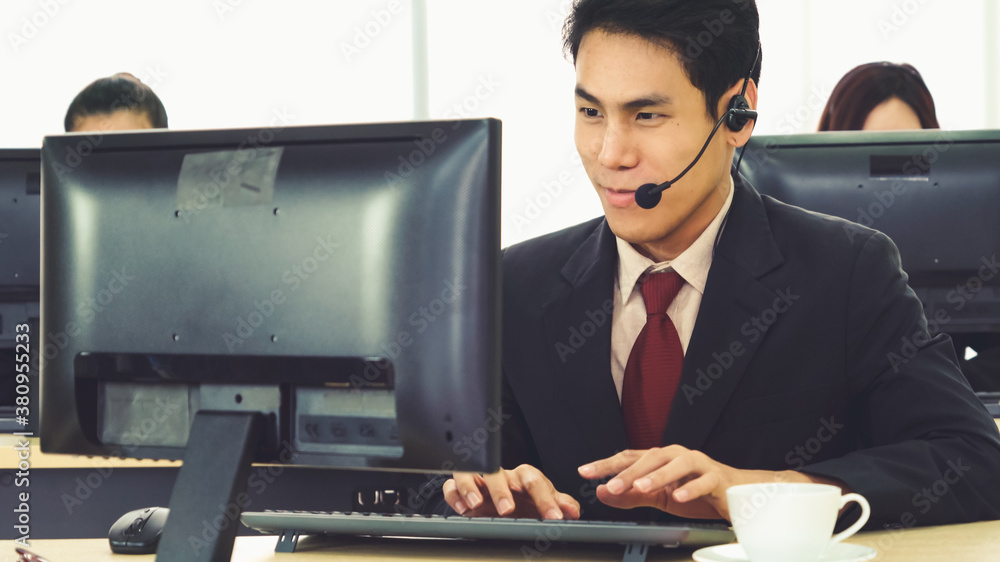 Business people wearing headset working in office to support remote customer or colleague. Call cent