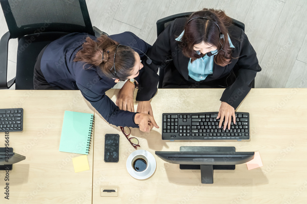 Business people wearing headset from top view in office working with computer to support remote cust