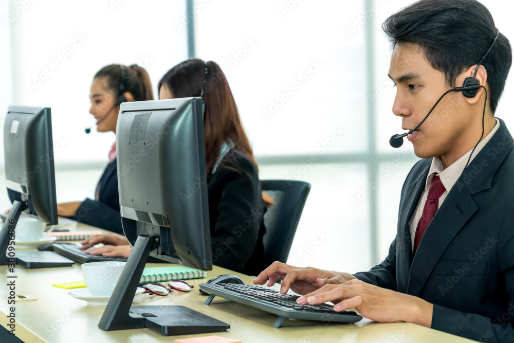 Business people wearing headset working in office to support remote customer or colleague. Call cent