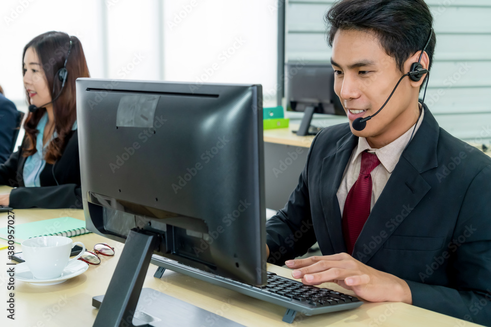 Business people wearing headset working in office to support remote customer or colleague. Call cent