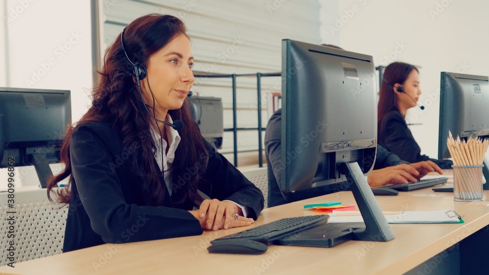 Business people wearing headset working in office to support remote customer or colleague. Call cent