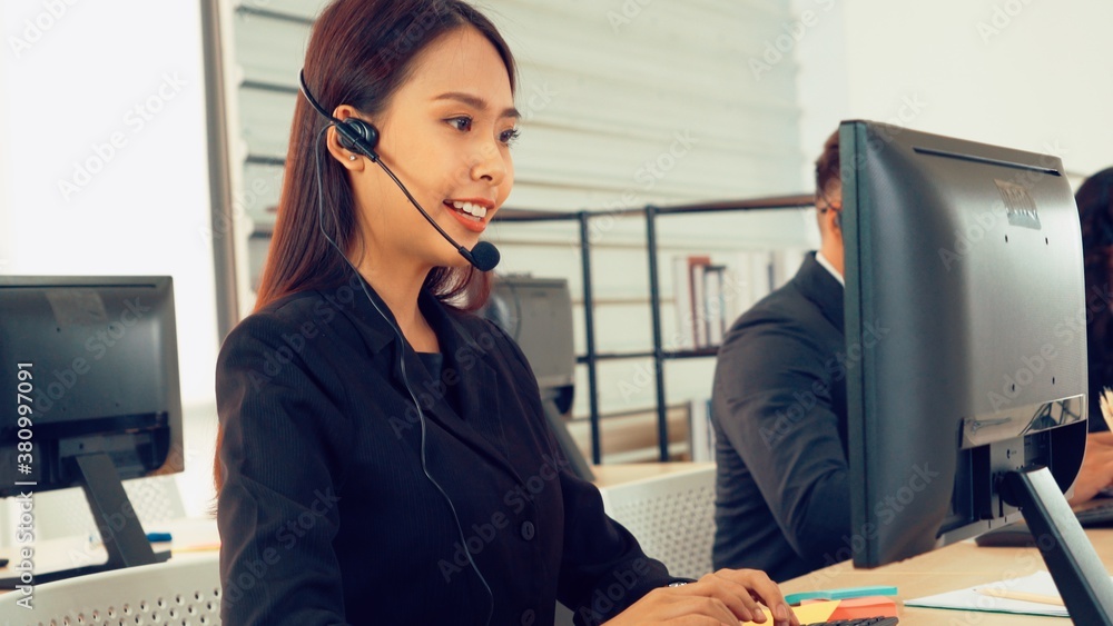 Business people wearing headset working in office to support remote customer or colleague. Call cent