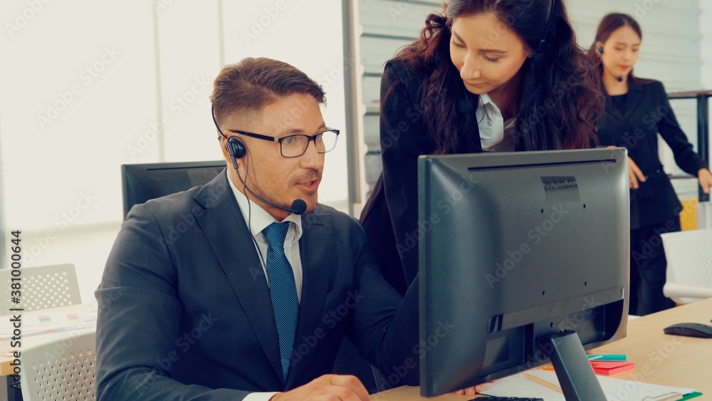 Business people wearing headset working in office to support remote customer or colleague. Call cent