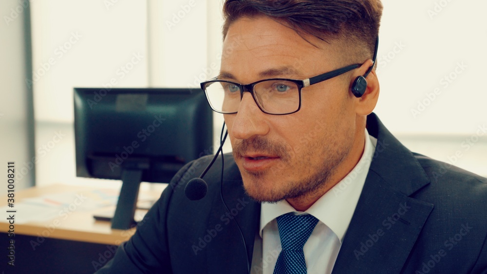 Business people wearing headset working in office to support remote customer or colleague. Call cent