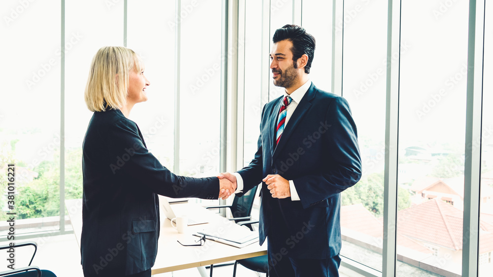 Business people handshake in corporate office showing professional agreement on a financial deal con