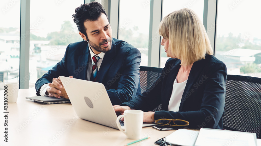 Two business people talk project strategy at office meeting room. Businessman discuss project planni