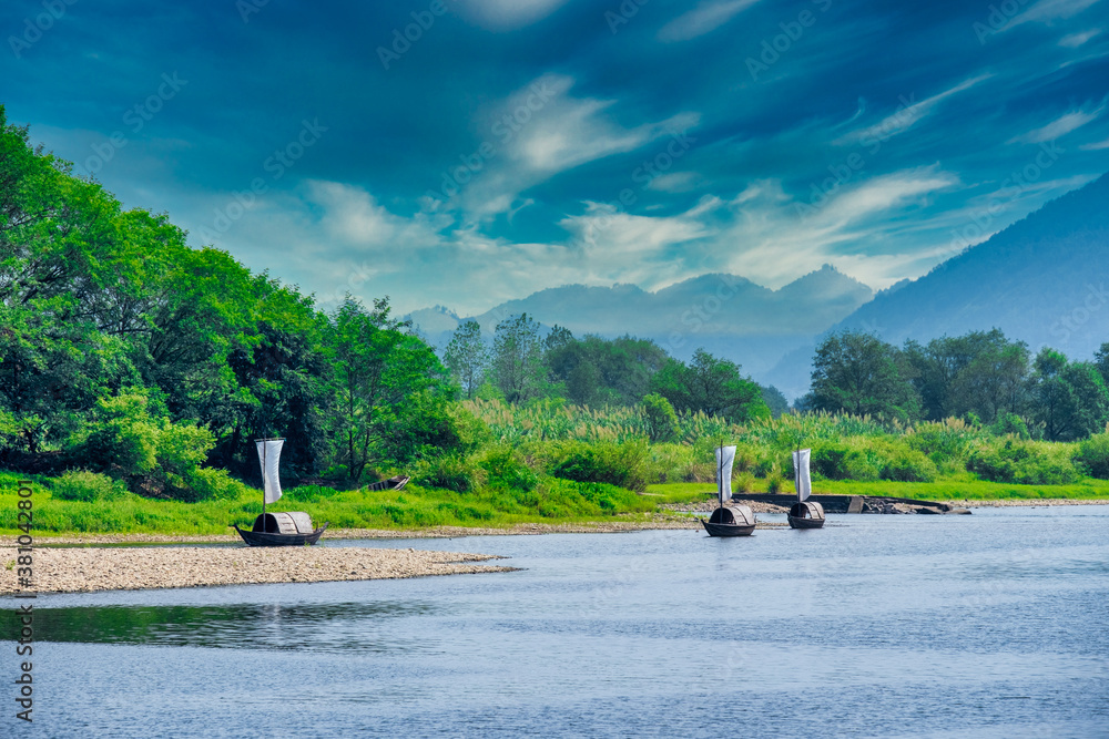 sailing boats in the river under bright sky