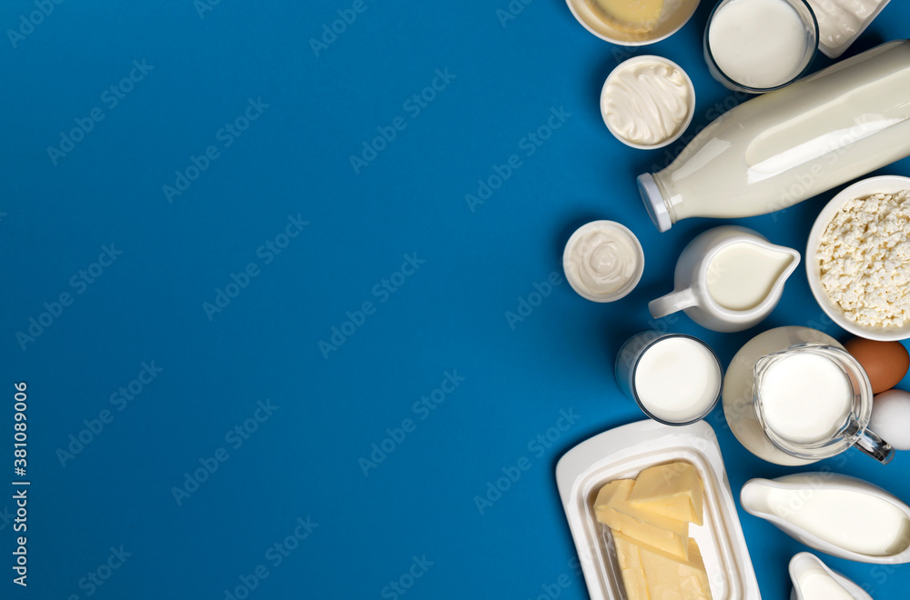 Collection of dairy products on blue background, top view