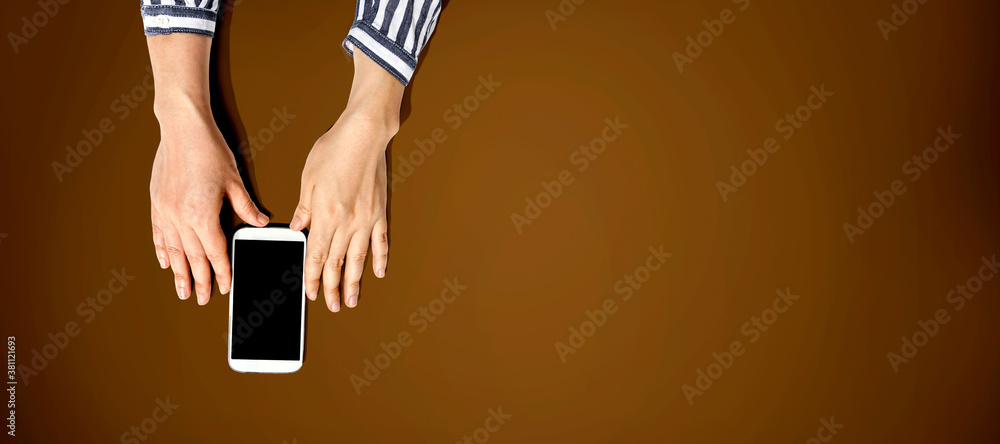 Person using a white smartphone from above