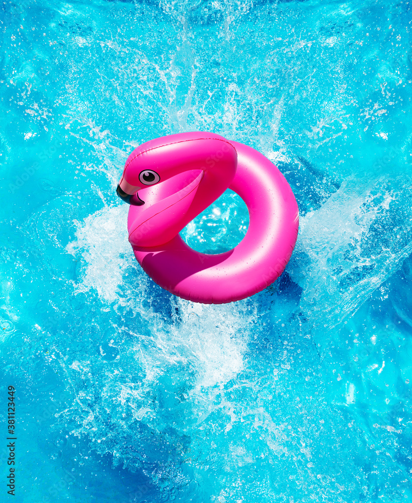 Inflatable flamingo buoy splash into the swimming pool view from above