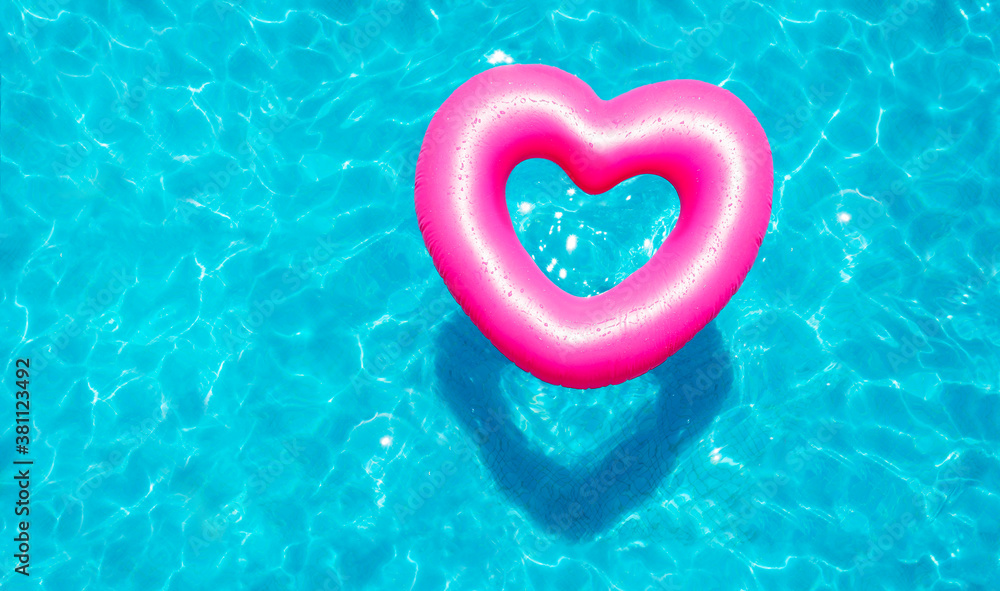 Inflatable rose heart buoy swim in the swimming pool view from above