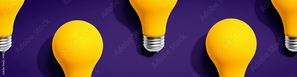 Yellow light bulb pattern with shadow - flat lay